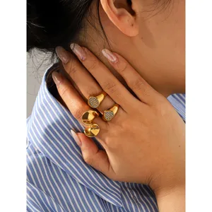 Minimalist stainless steel geometric rings detail view with heart and square pavé diamond styles.