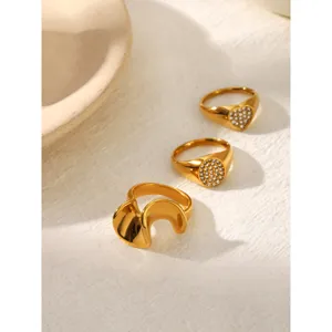 Gold stainless steel crystal rings detail shot, minimalist geometric design jewelry.