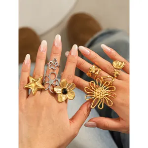 Stainless steel fashion flower and star rings detail display, elegant titanium steel design.