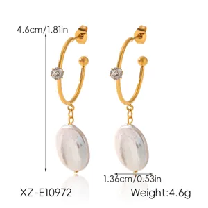 Detail view of the French vintage stainless steel hoop earrings with baroque pearls.