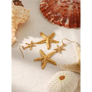 Gold stainless steel starfish earrings with crystal details, stylish marine style jewelry.