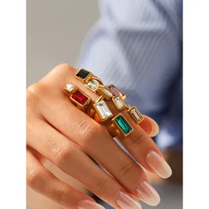 Close-up detail shot of geometric multi-color cubic zirconia stackable rings worn.