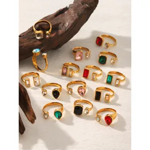 Detail shot of geometric zirconia open rings in stainless steel, luxury multi-color crystal style.