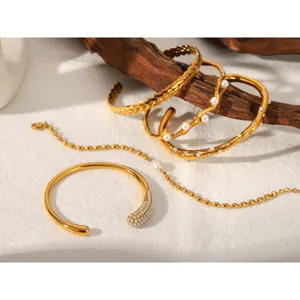 Detailed view of French vintage gold stainless steel pearl bracelets and cuffs, elegant jewelry set.