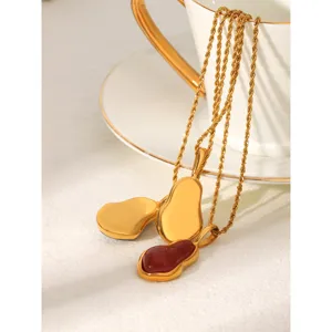 Detailed view of gold gourd pendant necklaces featuring smooth metal and red enamel designs.