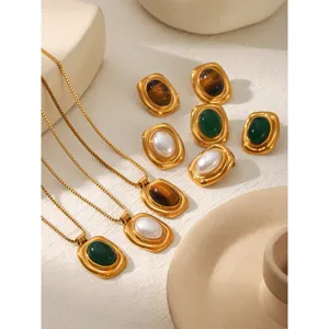 Detailed view of the luxury tiger eye stone stainless steel necklace and chic vintage earrings.