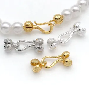 Gold and silver plated brass pepper shape jewelry clasps for DIY bracelets necklaces detail.