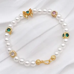 Gold-plated pearl bracelet with colorful stone charms and bow detail for DIY jewelry making.