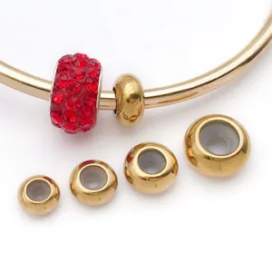 Stainless steel DIY jewelry detail view, gold plated stopper beads and red crystal charm.