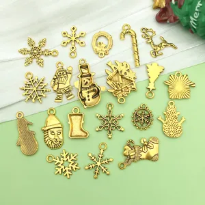 Detail shot of assorted gold Christmas charms, featuring snowflakes, snowmen, and festive pendants.