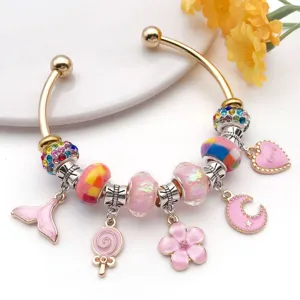 Pink charm bracelet detail with colorful rhinestones, cute pendants, and sweet DIY design.