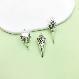 Vintage antique silver alloy bird skull pendant charms for DIY jewelry making and Halloween crafts.
