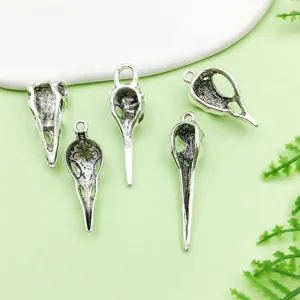 Vintage antique silver alloy bird skull pendants for DIY gothic Halloween jewelry crafting.