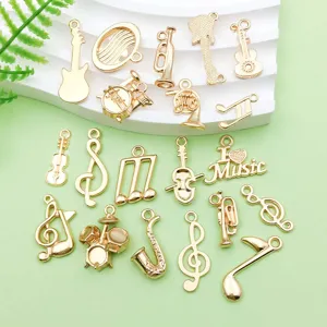 Gold music charms detail showing various instruments like guitar and drum for DIY jewelry making.