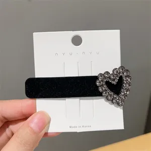 Black velvet hair clip with sparkling rhinestone heart design, elegant side hairpin accessory.