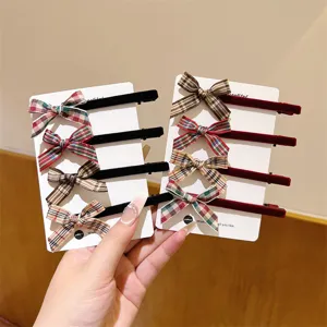 Sweet plaid ribbon and velvet bow hair clip detail shot, showing cute preppy style hair accessories.