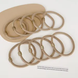 Gedetailleerd overzicht van beige elastische haarelastiekjes met metaal, duurzaam voor haarstijl.
