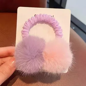 Plush pom pom hair tie detail view, cute fuzzy hair scrunchie accessory for kids.