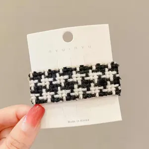 Classic black and white houndstooth hair clip, elegant tweed hairpin detail for women.