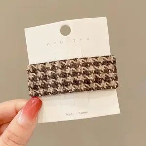 Brown houndstooth hair clip detail shot, stylish fabric side hairpin for women and girls.
