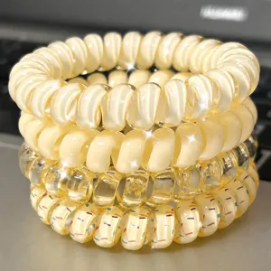 Detailed close-up of clear yellow telephone wire hair ties set with cute polka dot patterns.