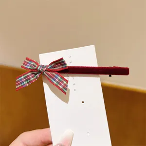 Sweet plaid ribbon bow hair clip detail view, featuring red velvet texture and cute ribbon design.
