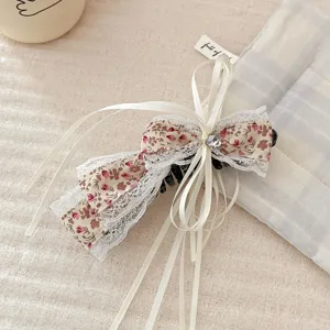 Forest romantic floral irregular bow hair clip with sweet ribbons for half-up hairstyles.
