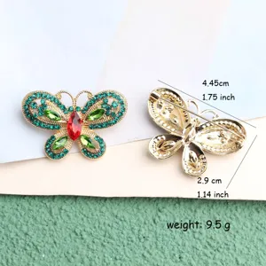 Exquisite butterfly brooch detail showcasing green rhinestone inlay and back pin structure.