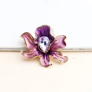 Exquisite oil-dropping purple crystal flower brooch detail, elegant coat pin accessory.