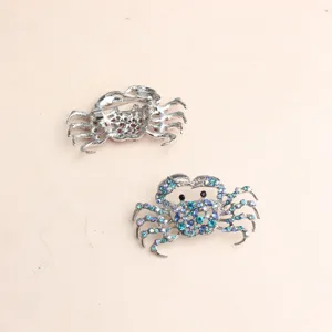 Detailed view of the sparkling rhinestone crab brooch showing crystal front and pin back.