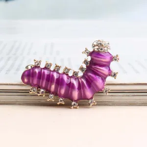 Closeup detail van de paarse emaille strass rups broche met glanzende kristalstenen.