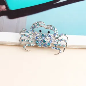 Close-up view of a sparkling blue rhinestone crab brooch, exquisite metal animal pin detail.