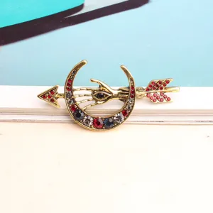 Vintage mystic evil eye hand crescent moon arrow brooch decorated with colorful sparkling rhinestones.