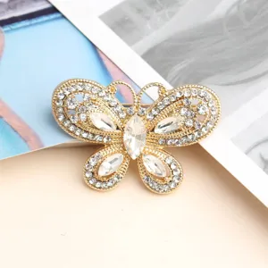 Gold butterfly brooch sparkling with clear crystal rhinestones, elegant fashion jewelry.
