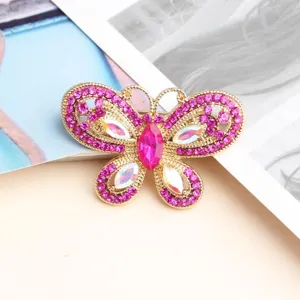 Stunning gold-plated crystal butterfly charm with vibrant pink rhinestones for exquisite nail art.