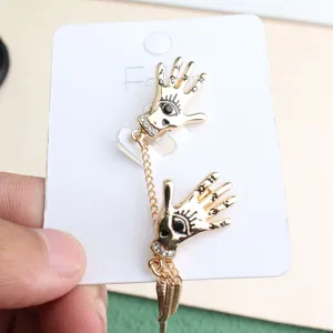 Detailed view of punk style evil eye hand brooch with chain alloy fashion jewelry accessory