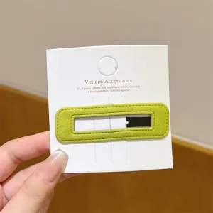 Green velvet hair clip detail view, soft texture side barrette, elegant minimalist hair accessory.