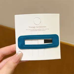 Detailed view of dark teal velvet hair clip, stylish autumn winter side barrette accessory.