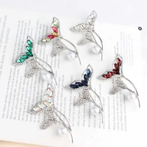 Elegant rhinestone fish tail pearl brooch pin, sparkling crystal fashion jewelry accessory detail.