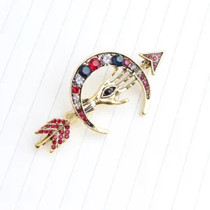 Vintage gold tone evil eye hand crescent moon arrow rhinestone brooch pin for fashion apparel.