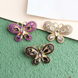 Set of three hollow rhinestone butterfly charms in purple, white and black for accessories.