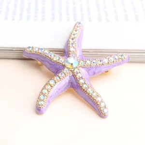 Purple starfish brooch crystal rhinestone gold trim ocean beach jewelry detail close up