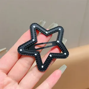 Black star hair clip with polka dot texture, cute side bangs snap clip detail view.