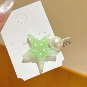 Close-up detail of the glitter green resin starfish and pearl hair clip, cute side hairpin.