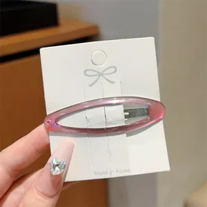 Minimalist translucent pink hollow oval hair clip detail view, elegant side bang snap hairpin.