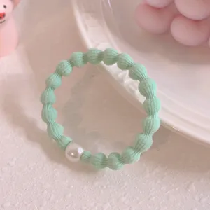 Light green bean hair tie with pearl detail, elastic hair rope for daily styling and ponytails.