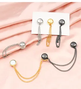 Detailed view of magnetic pant-cuff clips, hem cinchers with metal chains, multiple colors.