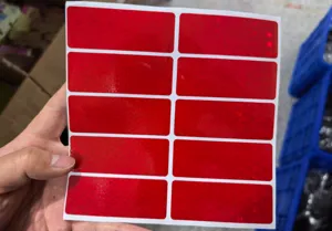 Red rectangular reflective tape stickers for electric cars, night safety and vehicle warning.