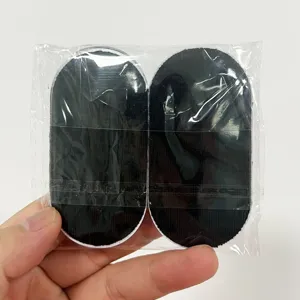 Anti-snoring mouth tape detail view showing black oval adhesive strips in clear packaging.