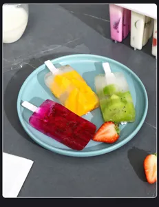 Homemade fruit popsicle mold detail showing delicious multi-flavor ice lollies and fresh fruits.